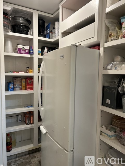 A white refrigerator with its door open is in a kitchen.