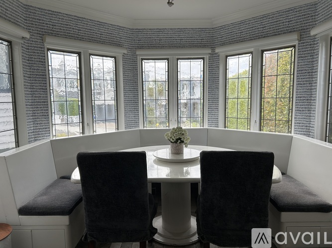 A dining area with a table and chairs.