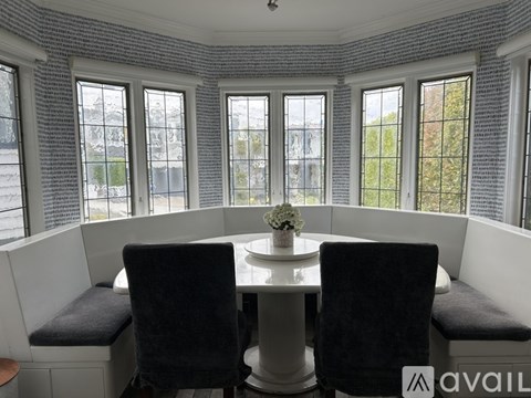 A dining area with a table and chairs.
