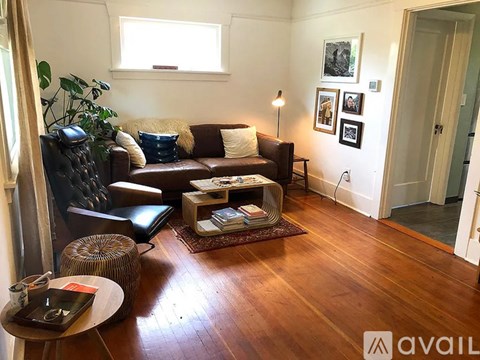 A living room with a brown leather couch and a wooden coffee table.