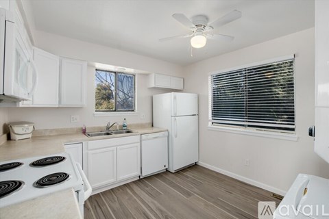 A kitchen with white cabinets and a black stove top.