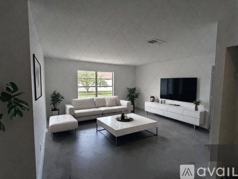 A modern living room with a white sofa set and a television.