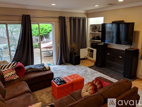 A living room with brown furniture and a flat screen TV.