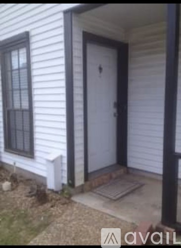A white door with a black frame is on the right side of a house.