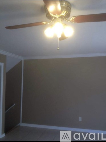 A room with a ceiling fan and lights.