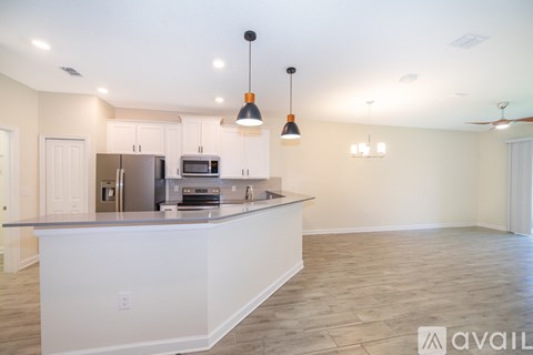 A kitchen with a white counter and a refrigerator.