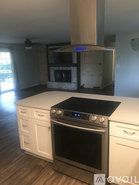 A modern kitchen with a stove top oven and a microwave above it.