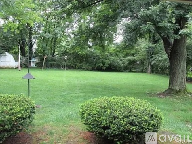 A green grass field with a triangular sign in the middle.