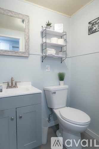 A white toilet sits next to a sink in a bathroom.