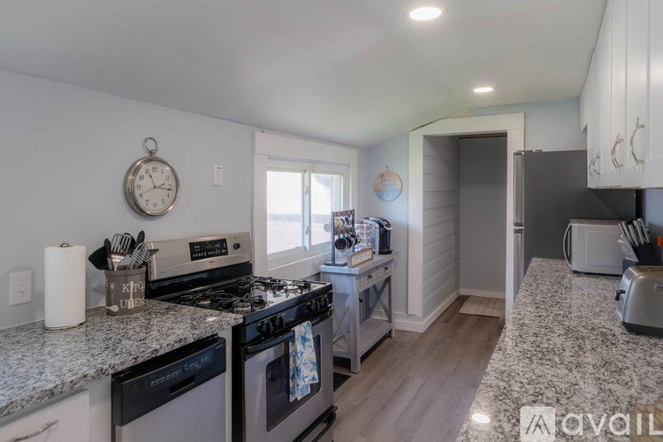 A kitchen with granite countertops and a stove top oven.