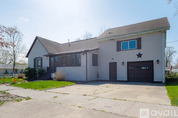 A house with a garage and a star on the door.