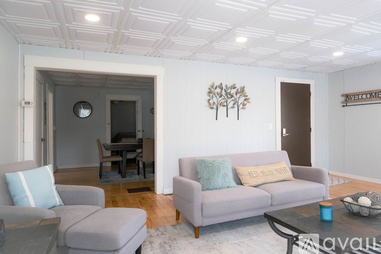 A living room with a grey couch and a coffee table.