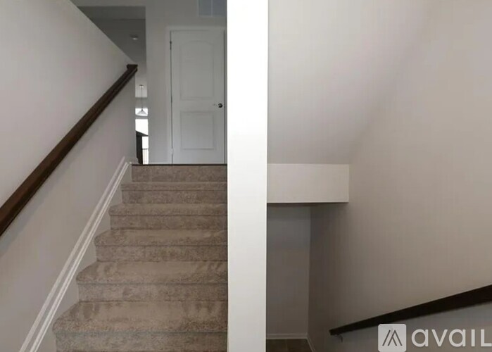A staircase with a white door at the top.