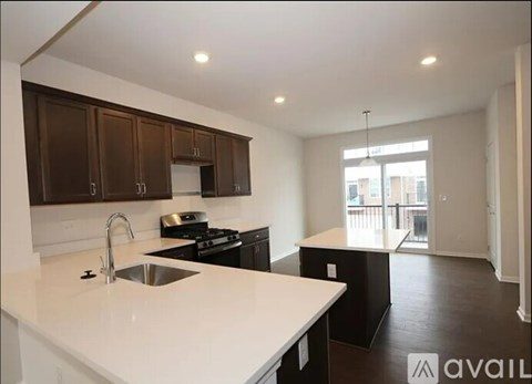 A kitchen with brown cabinets and a white counter top.
