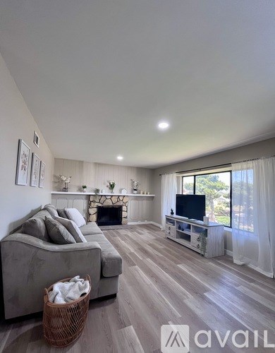 A living room with a grey couch and a television.