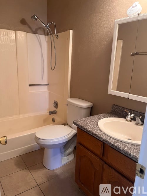 A bathroom with a toilet, sink, and bathtub.