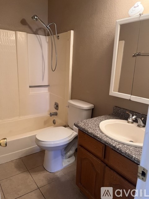 A bathroom with a toilet, sink, and bathtub.