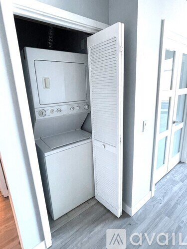 A white built in oven and microwave in a kitchen.