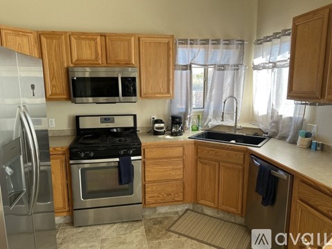 A kitchen with wooden cabinets and stainless steel appliances.