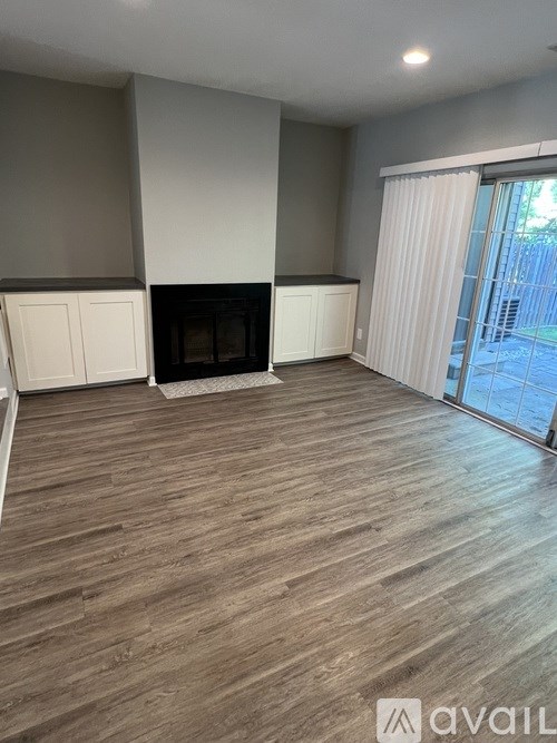 A living room with a fireplace and sliding glass doors.