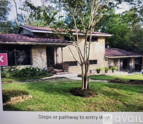A house with a tree in front and a sign that says "Steps or pathway to entry do not".