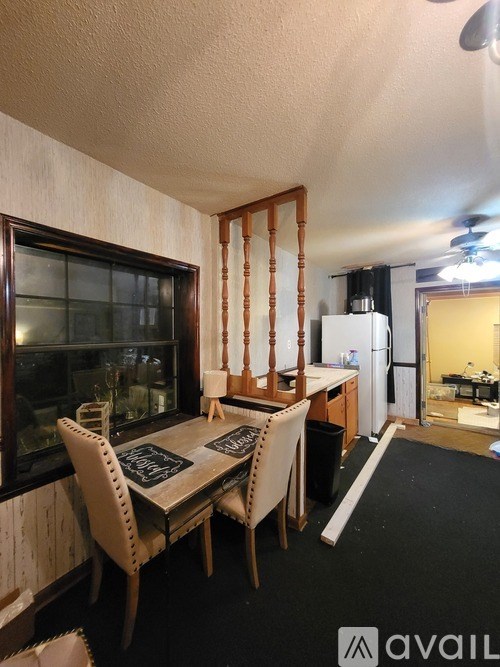 A dining area with a table and chairs.
