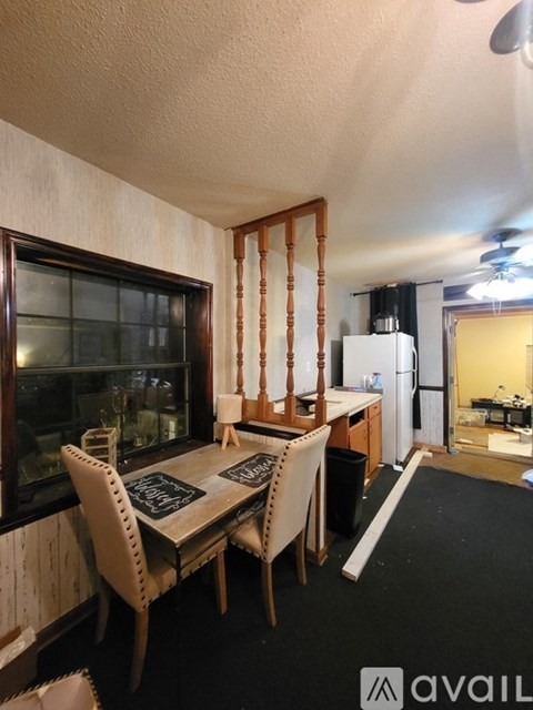 A dining area with a table and chairs.