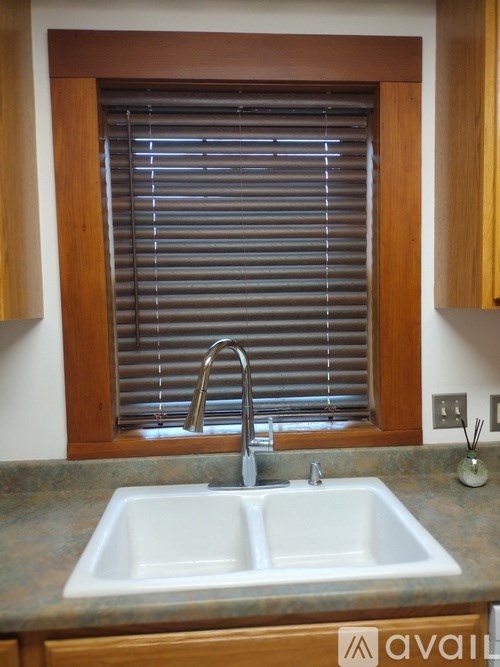 A kitchen sink with a window above it.