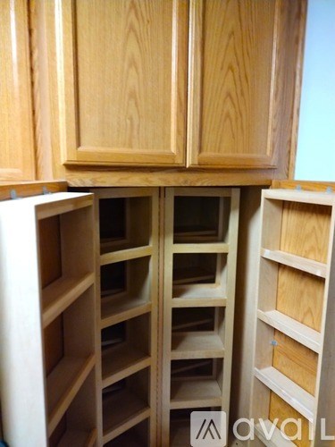 A kitchen with wooden cabinets and drawers.