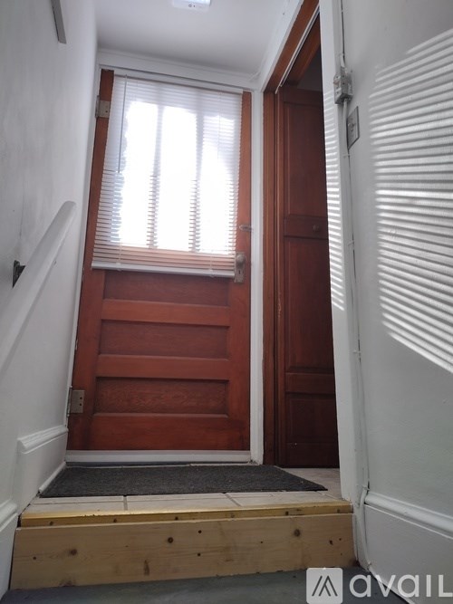 A wooden door with a window above it.