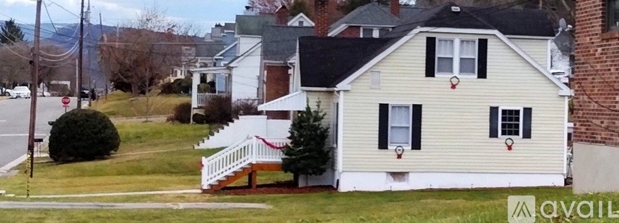 A house with a white fence and a red string is visible.