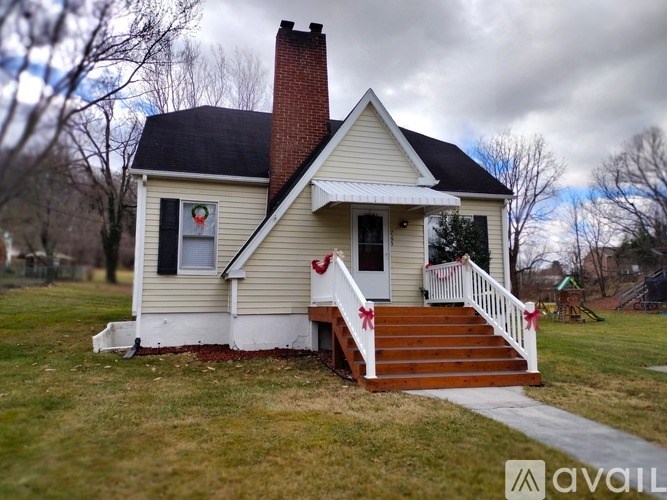 A small house with a red bow on the front door.