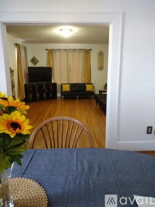 A living room with a couch and a television.