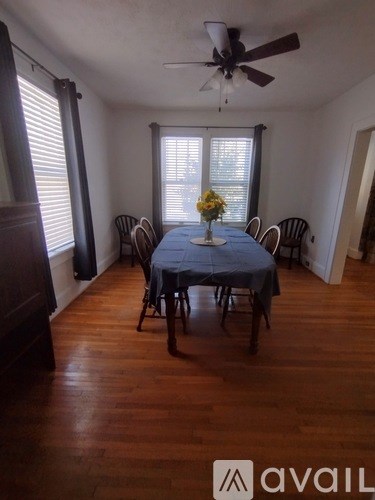 A dining room with a table set for four.