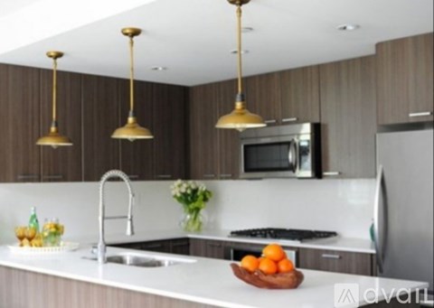 A kitchen with a sink, a refrigerator, and a microwave.