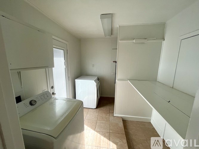 A small laundry room with a washer and dryer.