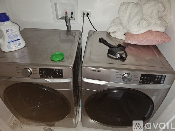 Two front loading washing machines are in a laundry room.