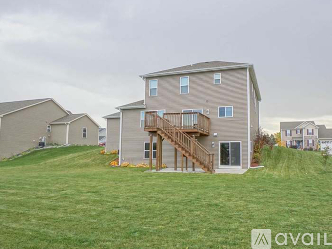 A house with a large front yard is available for rent.