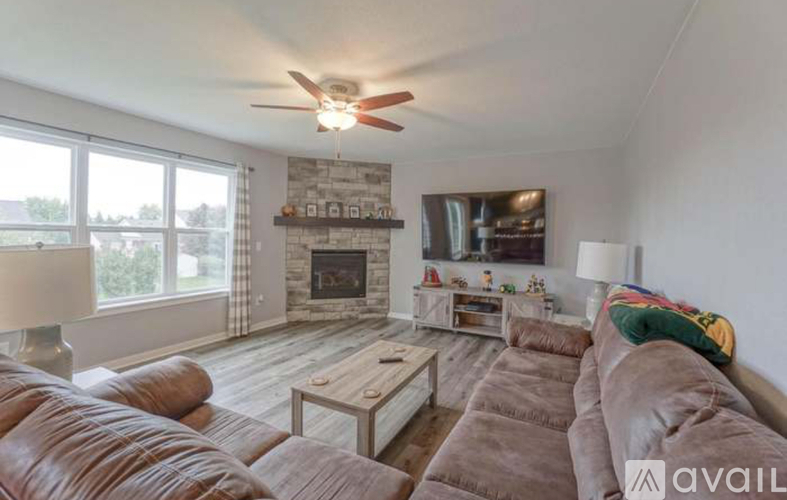 A living room with a fireplace and a large couch.