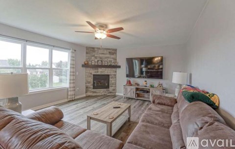 A living room with a fireplace and a large couch.