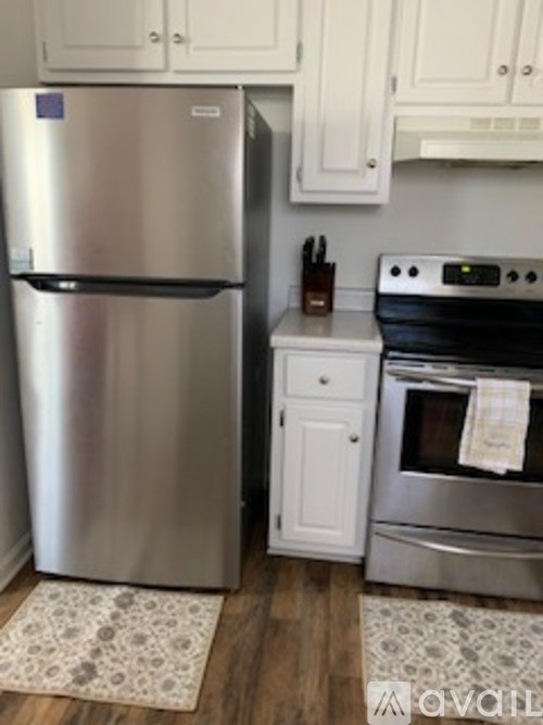 A kitchen with a stainless steel refrigerator and a stainless steel oven.