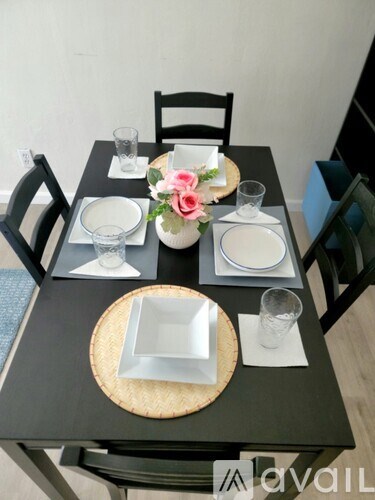 A table set for a meal with a floral arrangement in the center.