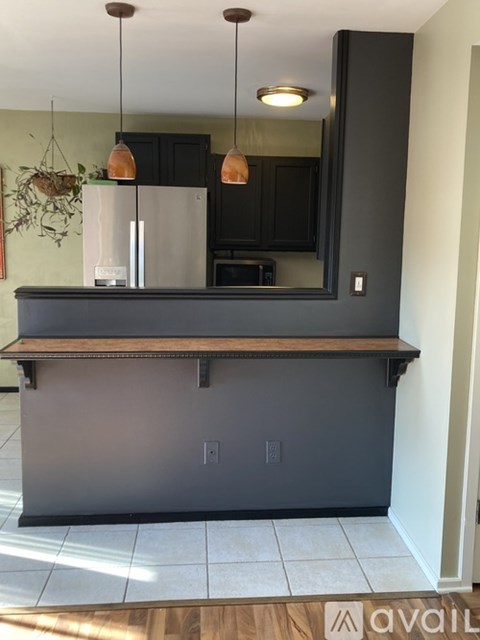 A kitchen island with a counter and a fridge on it.