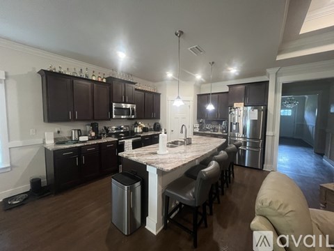 A kitchen with dark wood cabinets and a central island.