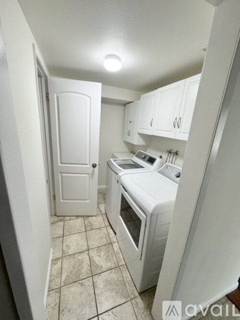 A small white kitchen with a stove and oven.