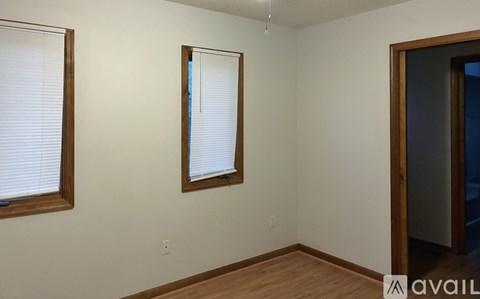 A room with a window and a door.