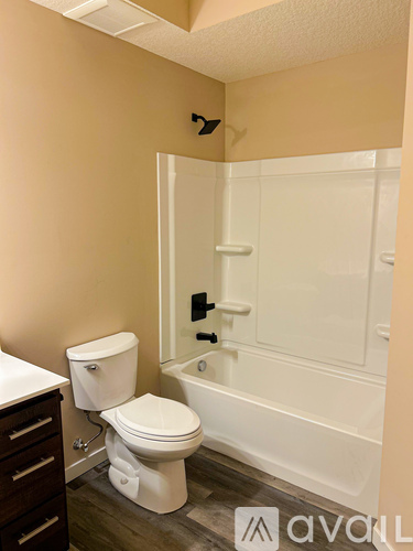 A hallway with a door on the left and a door on the right.