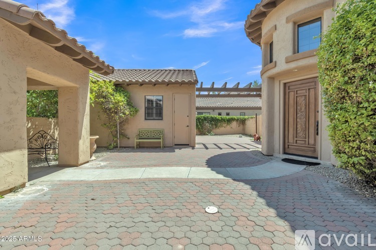 A house with a patio and a bench is for sale.