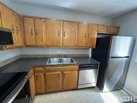 A kitchen with wooden cabinets and a black oven.