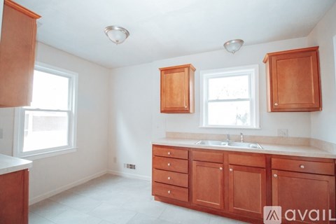 A kitchen with wooden cabinets and a white countertop.